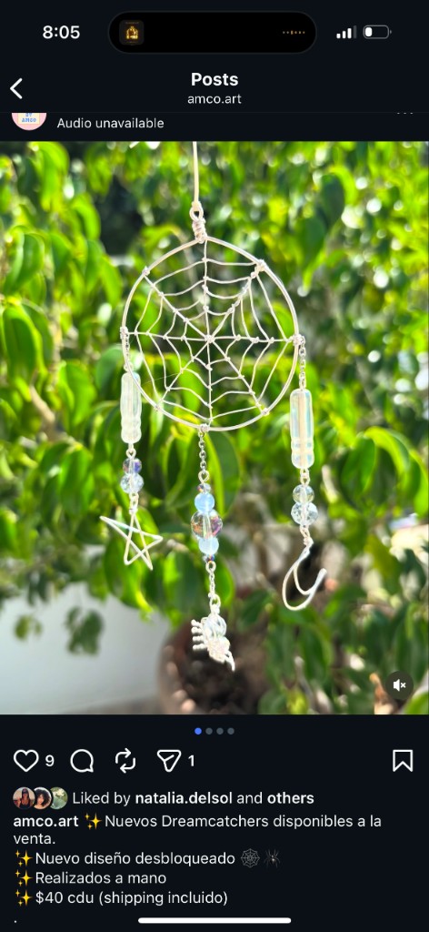 Handmade wire dreamcatcher with spider web center and beaded strands with moon, star, and spider charms.